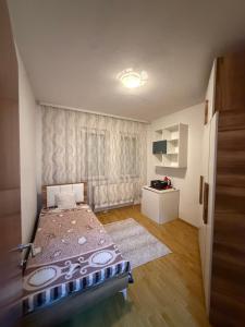 a small bedroom with a bed in a room at Rental House in Mitrovica