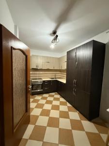 an empty kitchen with a checkered floor at Rental House in Mitrovica