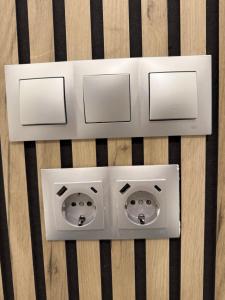 two electrical outlets on top of a wooden table at Hostal Fernández Atocha in Madrid