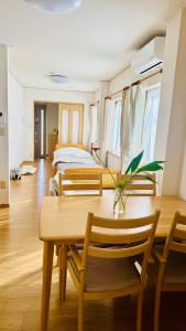 a dining room with a table and a bed at 街角TheStreetCorner in Noritake-Shinmachi