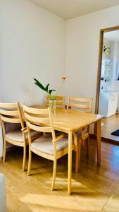 a wooden dining room table with chairs and a plant at 街角TheStreetCorner in Noritake-Shinmachi +17 photos