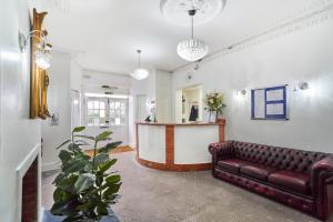 a living room with a couch and a table at Park Hotel in Ilford