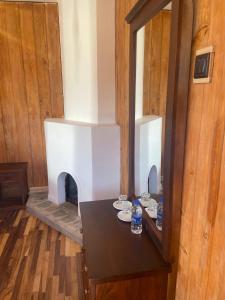a dining room with a table with a fireplace at Redwood inn homestay in Nuwara Eliya