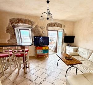 a living room with a couch and a table at Family Apartman Baška in Baška