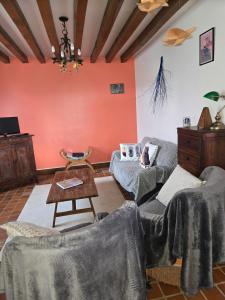 a living room with two couches and a table at Edelweiss in Moux-en-Morvan