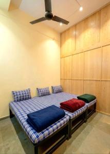 a bed with two pillows on it in a room at Vishram Yatri Niwas in Kolhapur