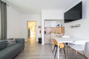 a living room with a couch and a table at COY Apartments Leoben - Central near Uni & Station with 24 7 Check-in in Leoben