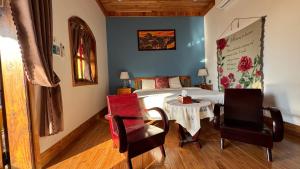 a bedroom with a bed and a table and chairs at Hoàng Doji de Villa in Thôn Dương Xuân Hạ +58 photos