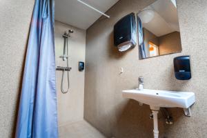 a bathroom with a sink and a shower at Guesthouse Andrea in Reykjavík +26 photos