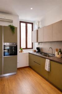 a kitchen with a sink and a stove at Marconi Home in Trieste