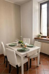 a white table with white chairs and a white dining room at Marconi Home in Trieste