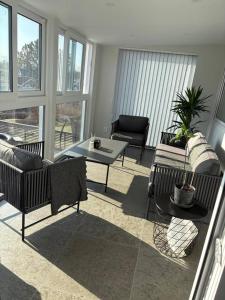 a living room with couches and a coffee table at Workers Stay - Temporary House Stockholm in Rönninge