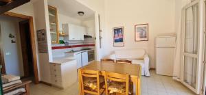 a kitchen with a table and chairs in a room at Best Holidays Pineta in Marcelli