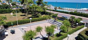 an overhead view of a park with palm trees and a street at Best Holidays Pineta in Marcelli