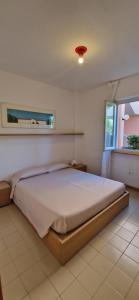 a bedroom with a large bed in a room at Best Holidays Pineta in Marcelli +16 photos