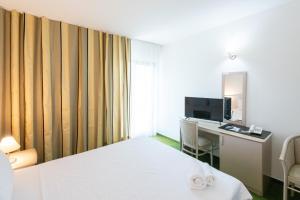 a hotel room with a bed and a desk at Complex Bran Brad Bega in Eforie Nord +26 photos