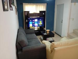a living room with a couch and a television at Casa completa equipada para cualquier ocasión in Tezoyuca