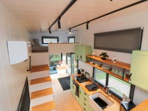 a kitchen in a tiny house with a large window at The Tiny Home in Yarm