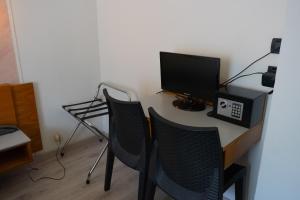 a desk with two chairs and a television on it at Hotel San Marco BB in Boario Terme