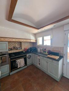 a kitchen with a stove and a counter top at Gîte des Gatinelles in Erbray