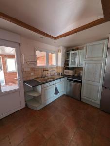 a kitchen with a sink and a refrigerator at Gîte des Gatinelles in Erbray +7 photos