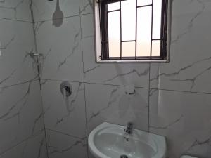 a bathroom with a sink and a window at Sweetwaters Guest House in Estcourt +15 photos