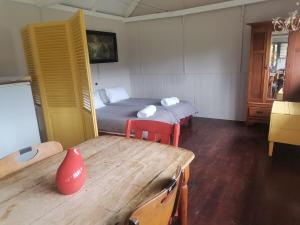 a room with a bed and a table and a table sidx sidx sidx at Rivendell Forest Retreat in Wilderness