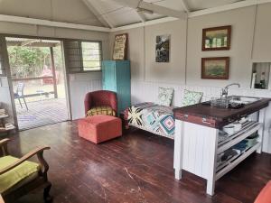 a kitchen with a counter and a couch in a room at Rivendell Forest Retreat in Wilderness