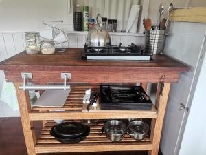 a kitchen counter with a stove and some pots and pans at Rivendell Forest Retreat in Wilderness
