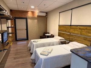 a hospital room with two beds and a tv at Casita de Ceci in Pilar