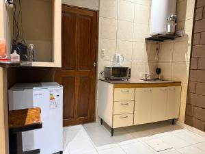 a small kitchen with a refrigerator and a microwave at Casita de Ceci in Pilar +1 photo