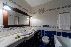 a bathroom with a sink and a toilet and a mirror at Mom Hotel Buyukada in Adalar +16 photos