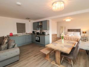 a kitchen and living room with a table and a couch at Toote Suite in Yarm