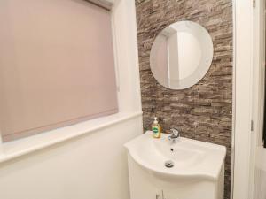 a bathroom with a sink and a mirror at Toote Suite in Yarm +9 photos