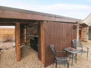 a wooden fence with two chairs and a table at Toote Suite in Yarm