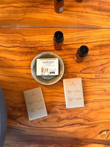 a wooden table with a bowl of food and some notes at CasaGozzante in Pienza