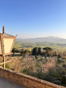 a street light on a wall looking out over the countryside at CasaGozzante in Pienza