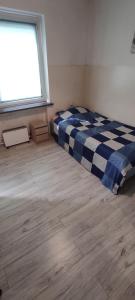 a bedroom with a bed in a room with a window at Adam room 2 in Wrocław