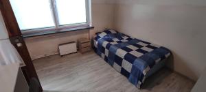 a small bedroom with a bed in a room with a window at Adam room 2 in Wrocław