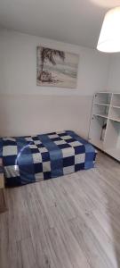 a bedroom with a bed with a blue and white at Adam room 2 in Wrocław