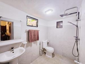 a white bathroom with a sink and a toilet at The Coast Haven in Tangalle +43 photos
