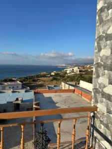 a bench sitting on top of a building with the ocean at ZAHA Appart in Ksar es Sghir +16 photos