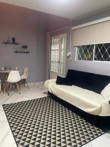 a bedroom with a bed and a black and white rug at Condomínio Central Casa Luíza in Uruguaiana