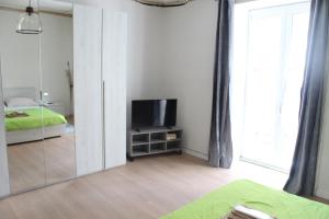 a bedroom with a mirror and a tv and a bed at La Vinella in Lamezia Terme