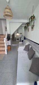 a living room with two beds in a room at Vivienda Turística de Alojamiento Rural - Labrucena in Abrucena