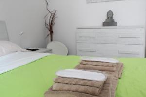 a bedroom with a bed with towels on it at La Vinella in Lamezia Terme