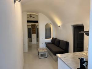 a living room with a couch and a table at Theodora Suites in Oia