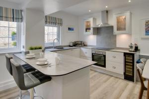 a kitchen with white cabinets and a large island at 2 Bed in Kingsbridge oc-bc3188 in Kingsbridge