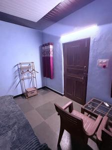 a room with a bed and a table and a door at Barefoot and Beyond - Crafted with Kenchas in Gokarna