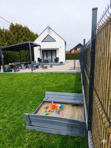 a sandbox with a toy in the sand in a yard at Ekologiczny domek "Ciszyca" z widokiem na Śnieżkę in Kostrzyca +44 photos
